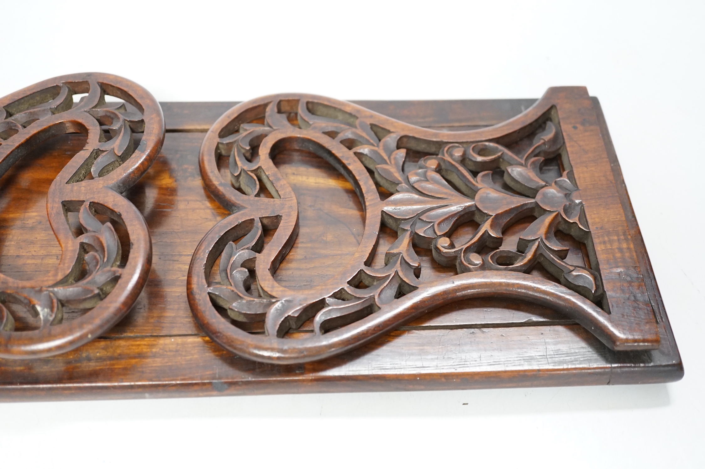 A 19th century rosewood book slide with fretted sides, base 39cm wide